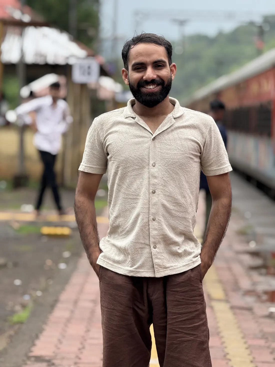 Nuhman standing on a Kerala railway platform