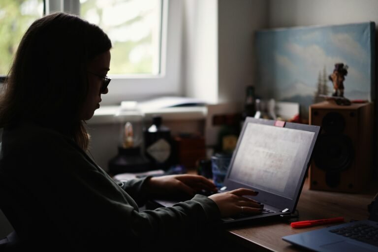 Zero-Cost AI Operations Agent for Solo Agencies (2026 Guide) Solo agency owner working on laptop at desk with clean automated workflow setup