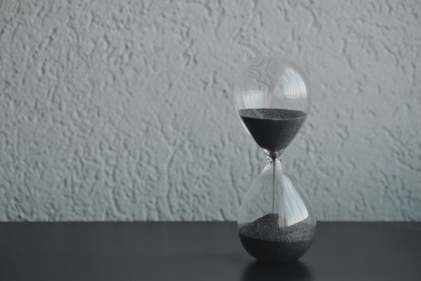hourglass resting on smooth granite