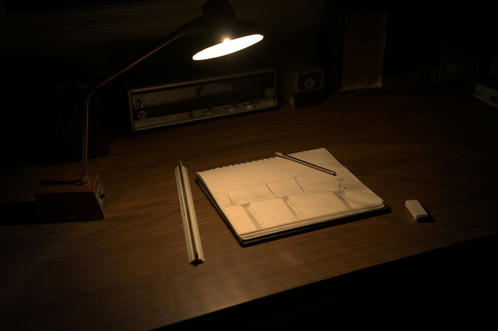 Hardcover notebook resting on a clean desk under a warm evening lamp