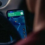 Close up of hands using Google Maps navigation on a smartphone
