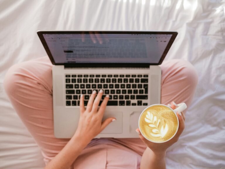 Selling Digital Products on Etsy & Gumroad: A Complete Guide to Building Income Freelancer working remotely with coffee and laptop